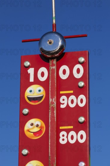 Close-up of High Striker game of strength with numbered score levels at Fun Show traveling