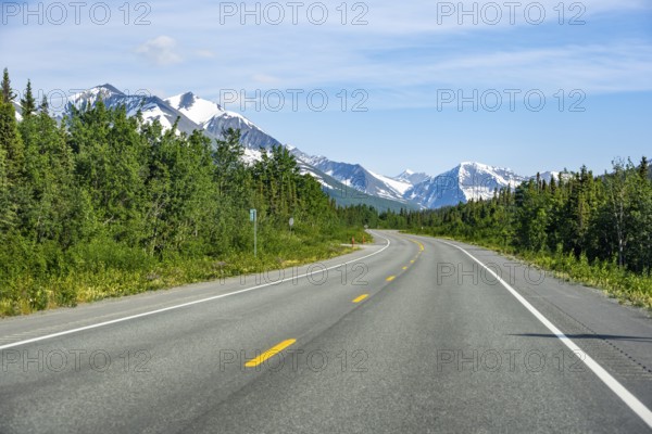 Road through taiga and mountainous landscape, picturesque landscape on Richardson Highway, Alaska,