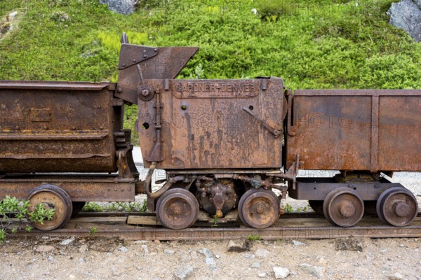 Old rusted mine trucks from the former Gold Mine Independence Mine in mountainous landscape,