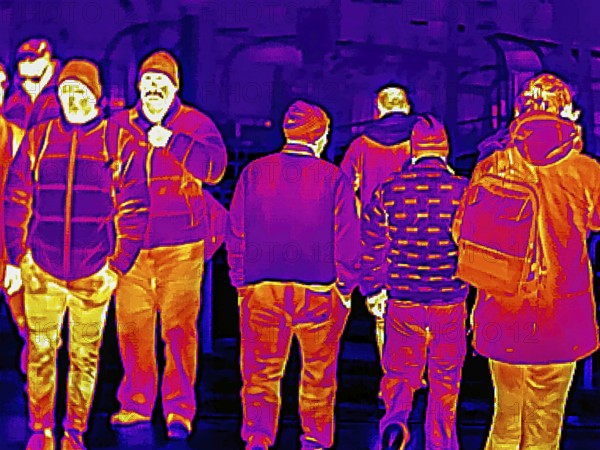 Thermal image or thermography, symbolic photo, interpolated. People traveling in urban areas.