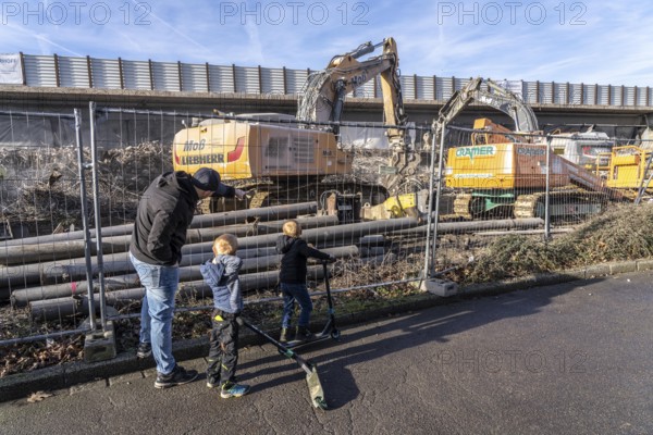 Spectators, teethers during the demolition of the 120 meter long motorway bridge of the A516,