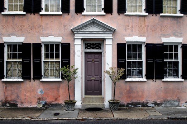Pink-painted historic house with multiple windows in Charleston, Charleston, South Carolina, USA
