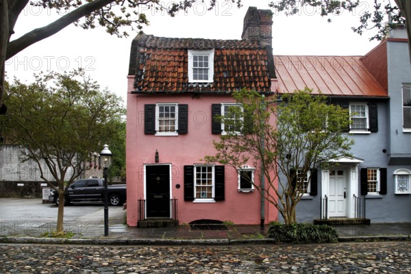 Charming, colorful house with historic flair under trees in Charleston, Charleston, South Carolina,