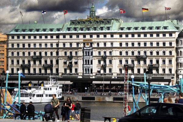 The Grand Hotel in Stockholm on Blasieholmen with a passing boat, Stockholm, Södermanland, Sweden