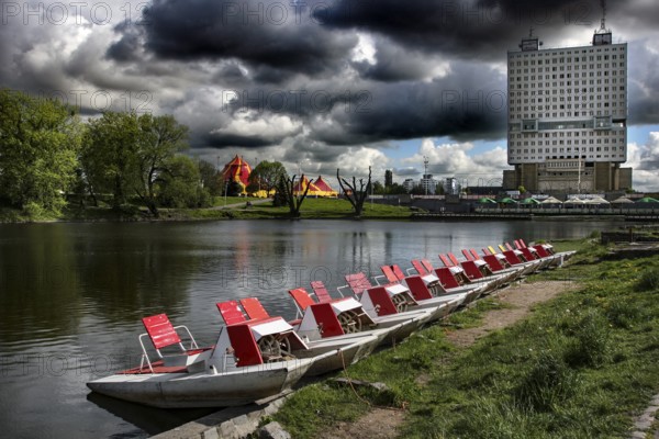 Boats on the castle pond with the imposing House of Councils in the background, Kaliningrad,