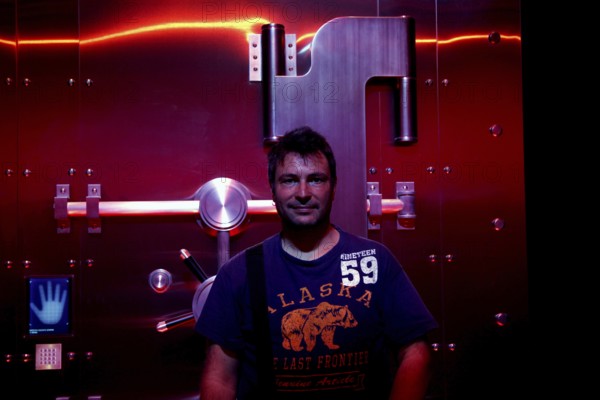 A man stands in front of a futuristic illuminated safe in the Coca-Cola Museum in Atlanta, Atlanta,