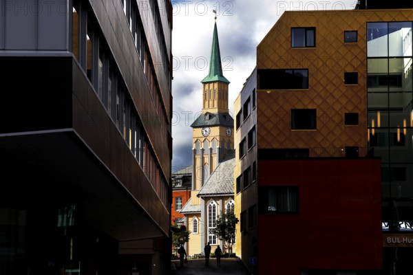 View of the cathedral between modern buildings in Tromsø, Tromsø, Troms, Norway