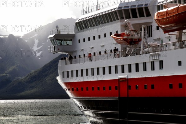 Close-up of a Hurtigruten ship next to the coastline of Øksfjord, Øksfjord, Norway