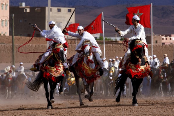 Riders in traditional clothing perform at Fantasia during the Fête des Roses, El Kelâa m'Gouna,