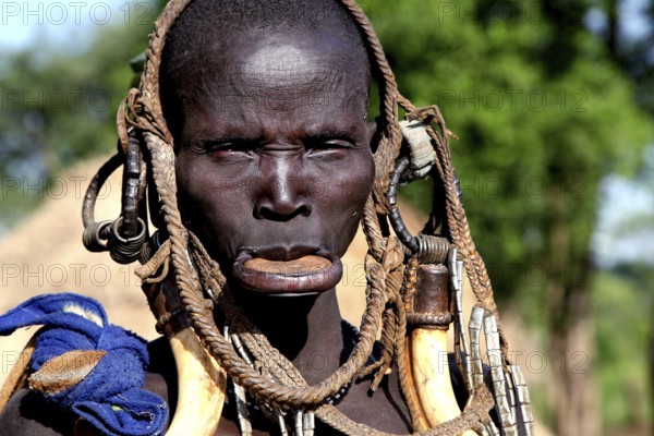 Mursi woman with a large lip plate and traditional clothes in Mago National Park, Mago National
