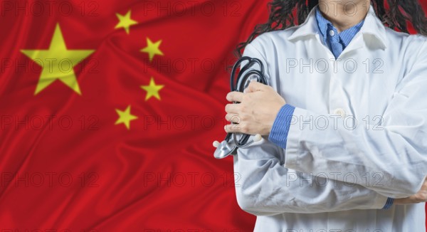 Healthcare professional with China flag background. Professional doctor holding stethoscope on