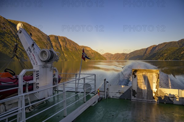 Ferry trip on Lysefjord at sunrise with mountains and waves in the background, Lysefjord, Rogaland,