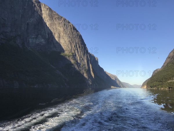 Lysebotn, Rogaland Municipality, Norway, view of the trail of a boat in the quiet Lysefjord between