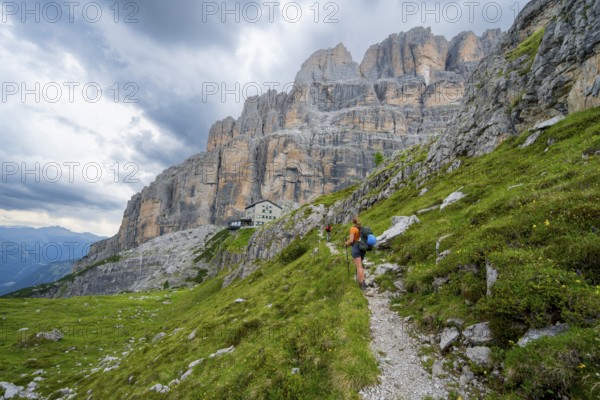 Female mountaineer on a hiking trail in front of Rifugio Maria E Alberto Ai Brentai, mountainous