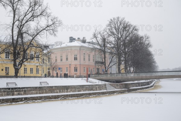 Historic buildings on the frozen Aurajoki river, wintery Turku or Swedish Åbo, Varsinais-Suomi,