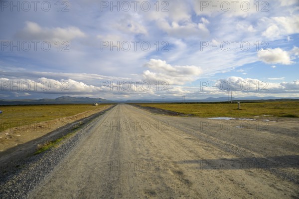 Falkvålen, Bruksvallarna, Jämtland, Sweden, long straight road in a wide landscape under a gently