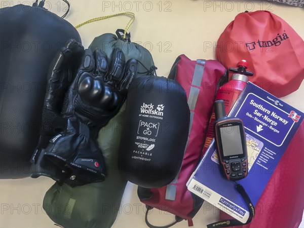 Bakum, Melle, Lower Saxony, Germany, camping equipment on a table with tent, stove, gloves and GPS