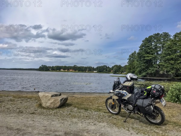 Urshult, Kronobergs län, Sweden, BMW G 650 GS Sertao enduro motorcycle next to a lake under cloudy