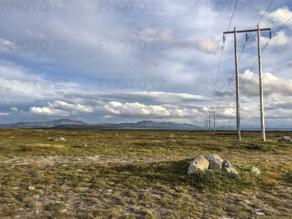 Ljungdalen, Jämtlands län, Sweden, wide landscape with electricity poles on the horizon under a