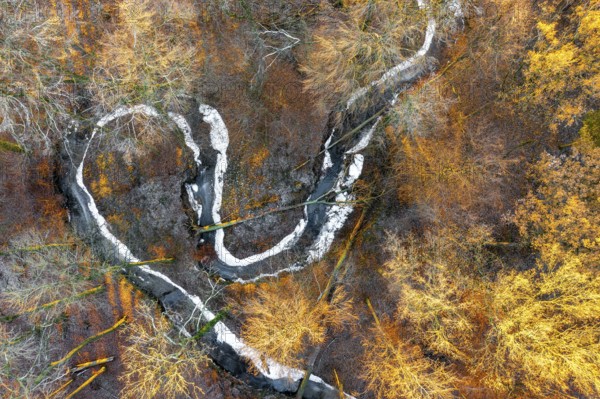 Frozen Määnder river loop of a stream in the Osnbrücker Land seen from the air, Melle, Lower