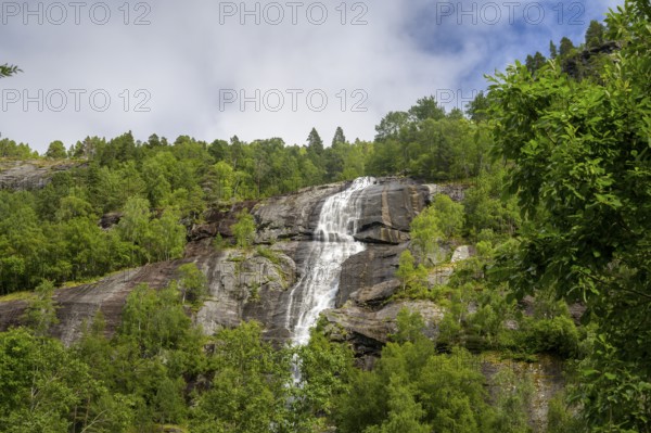 Åndalsnes, Møre og Romsdal Province, Norway, High Waterfall flows over steep rocks surrounded by