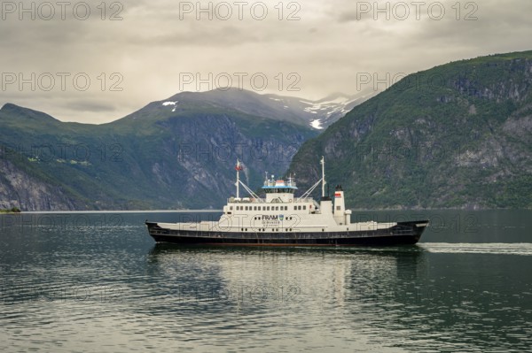 Valldal, Møre og Romsdal province, Norway, Fram Geiranger ferry in calm water surrounded by high