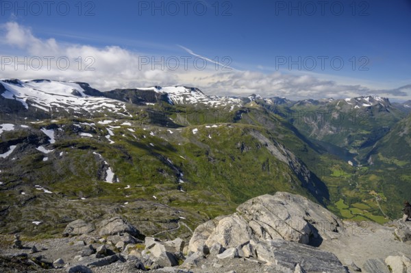 Geiranger, Møre og Romsdal province, Norway, view over snow-capped mountains and a green valley