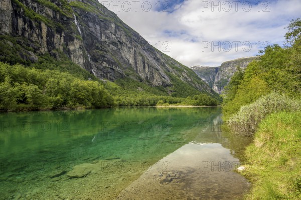 Åndalsnes, Møre og Romsdal province, Norway, Clear river surrounded by green landscape flanked by