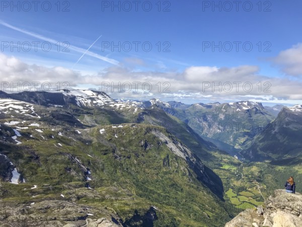 Geiranger, Møre og Romsdal province, Norway, panorama of mountains and green valley under blue sky