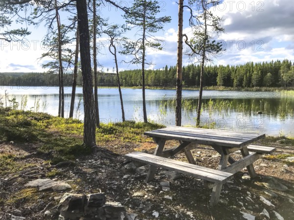 Storsjö Kapell, Jämtlands län, Sweden, A Scandinavian picnic table with fixed benches on the shore