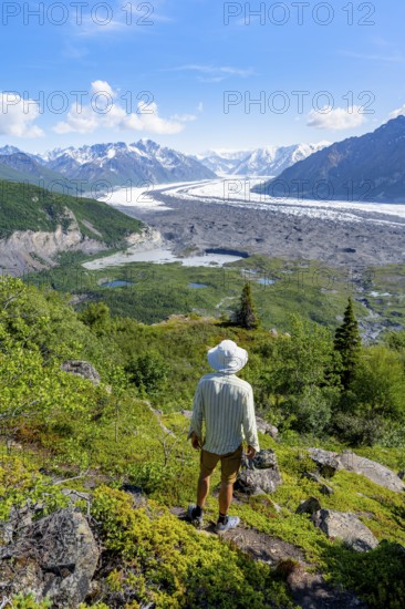 Young man enjoying the view, view of impressive mountain landscape with Matanuska glacier and