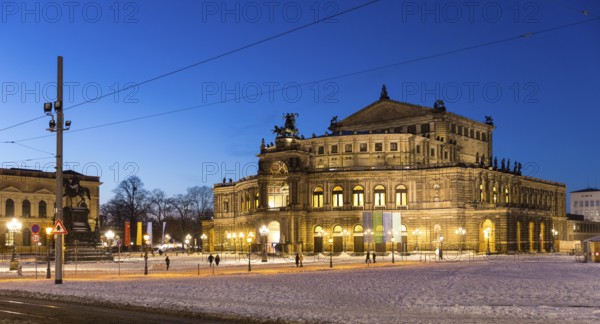 Illuminated Semper Opera House and Theatre Square with snow at dusk, Old Town of Dresden, Saxony,