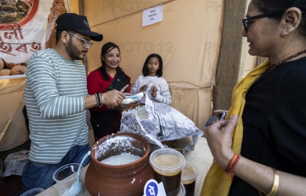 Vendor selling curd and cream dairy product at a stall in Bhogali Mela, ahead of the 'Magh Bihu'