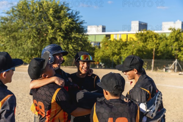 Young baseball players enjoying a moment of camaraderie and success, smiling and embracing after a