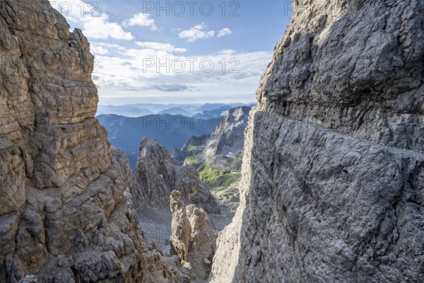 View from the Bocca degli Armi gap, mountaineers on a rock band on the Via Ferrata Bocciere
