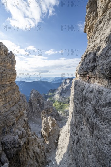 View from the Bocca degli Armi gap, mountaineers on a rock band on the Via Ferrata Bocciere