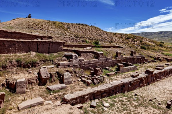 Historic ruins with terraces in rocky landscape under a clear sky, The archaeological site with the