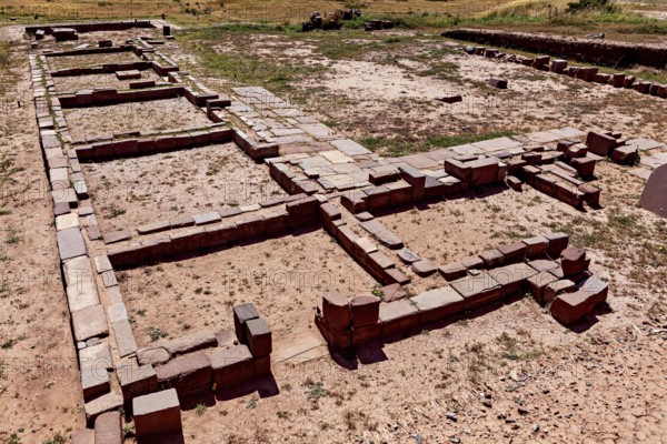Floor plans of stone ruins in an open area under clear skies, The archaeological site with the