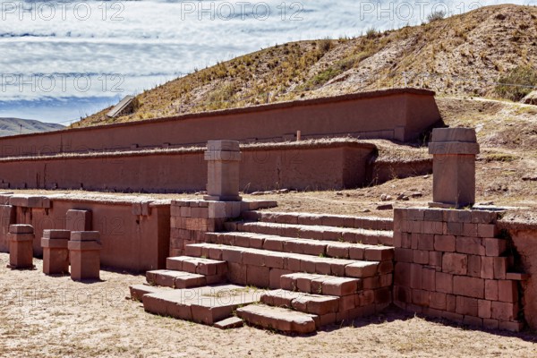 Historic ruins with stairs in a desert landscape under clear skies, The archaeological site with