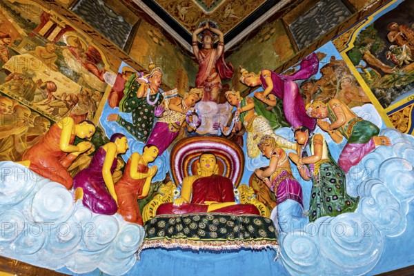 Buddha scene with figures standing in prayer surrounded by colorful frescoes and vivid colors, The