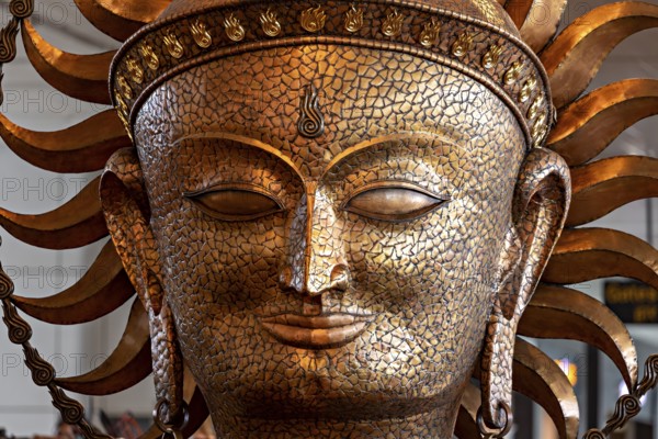 Golden sculpture of a face with solar elements, ancient art style with ornate details, portrait of