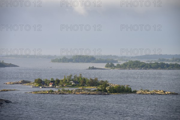 Small islands in the sea under a cloudy sky, calm and peaceful atmosphere, Aland Archipelago,