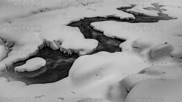 Ilsenburg, Saxony-Anhalt, Germany, A frozen one on the Ilse river in the Harz National Park on the