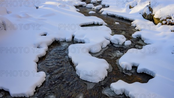 Ilsenburg, Saxony-Anhalt, Germany, snowy Ilse river in the Harz National Park on the Heinrich-Heine