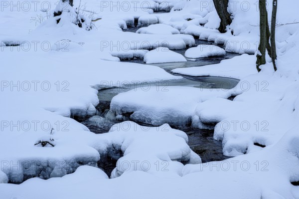 Ilsenburg, Saxony-Anhalt, Germany, path of a snowy little river Ilse in the Harz National Park on