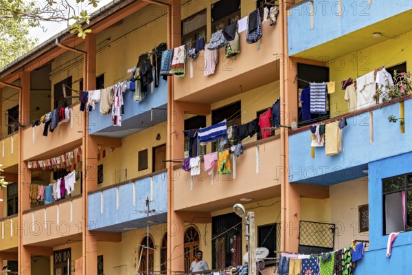 Apartment building with colorful facades and laundry hanging on the balconies, apartment building