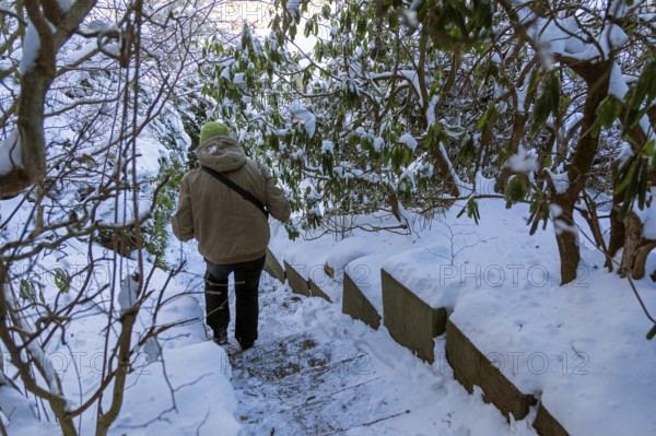 Woman walking down icy stairs, winter, snow, ice, Sieversen, Samtgemeinde Rosengarten, Lower