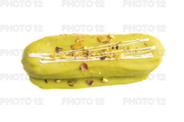 Glazed green Eclair on brown concrete isolated on white, top view, flat lay, close up