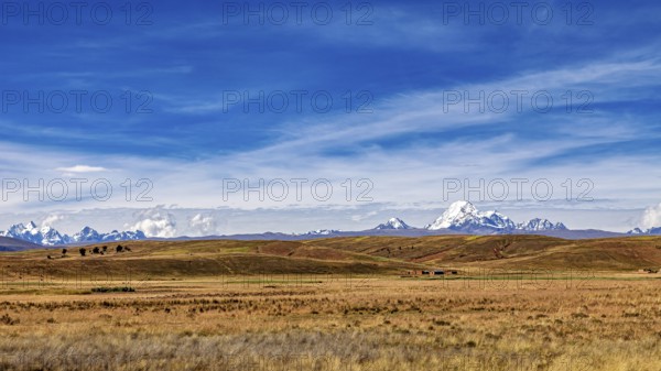 Wide hilly landscape with mountains and a cloudy sky, The Altiplano landscape in the Andes of