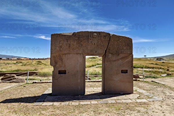Monumental stone gate on a wide area with blue sky in the background, The archaeological site with